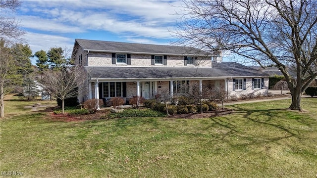 traditional home with a porch and a front lawn