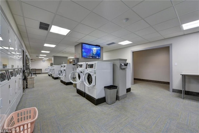 common laundry area featuring visible vents, washing machine and dryer, carpet flooring, and baseboards