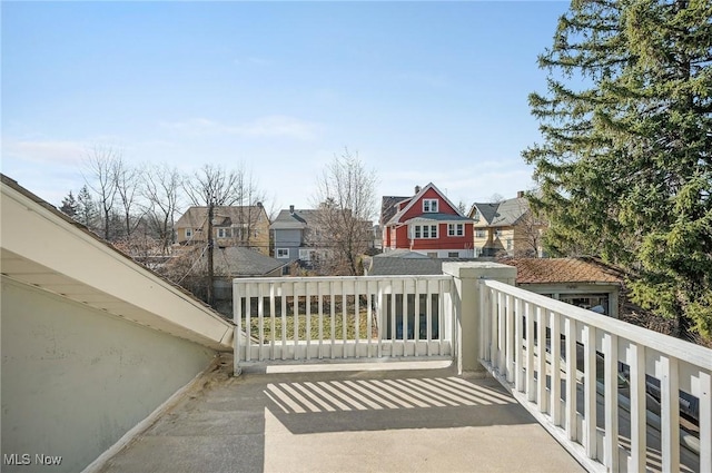 exterior space featuring a balcony and a residential view