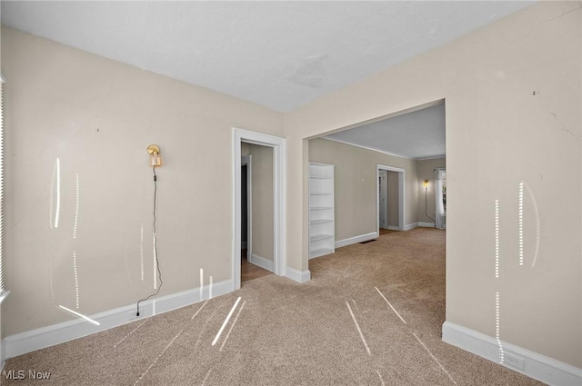 interior space featuring baseboards and carpet floors