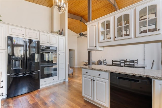 kitchen featuring light wood-type flooring, black appliances, glass insert cabinets, wood ceiling, and ceiling fan