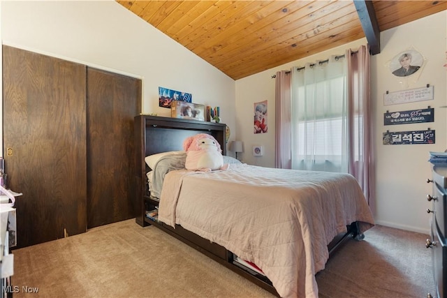 carpeted bedroom featuring lofted ceiling, a closet, baseboards, and wooden ceiling