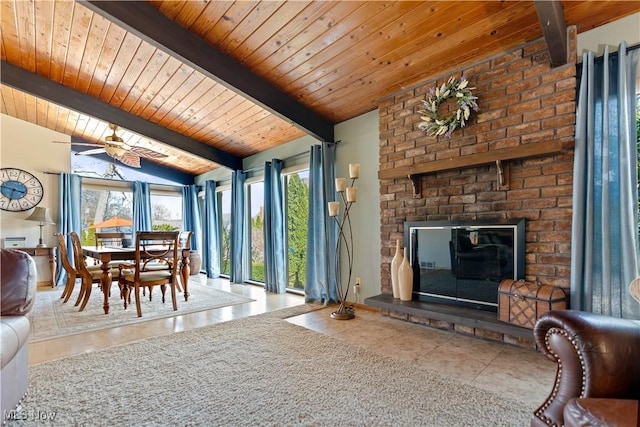 living room featuring a fireplace, tile patterned flooring, wood ceiling, ceiling fan, and vaulted ceiling with beams