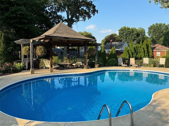 pool with a gazebo and a patio