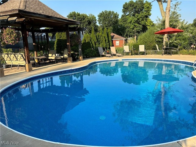 outdoor pool with a patio area and a gazebo