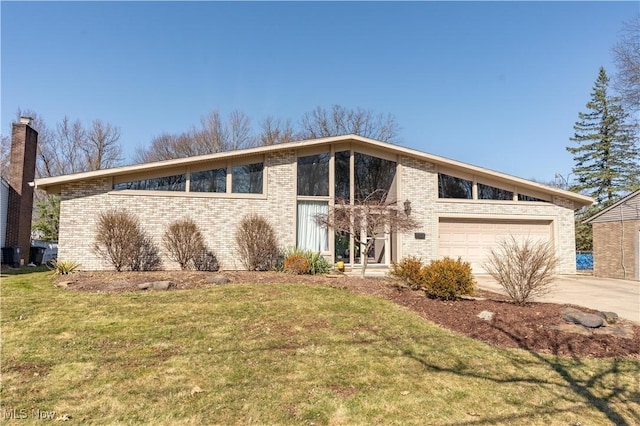 mid-century home with concrete driveway, a front yard, a garage, brick siding, and a chimney