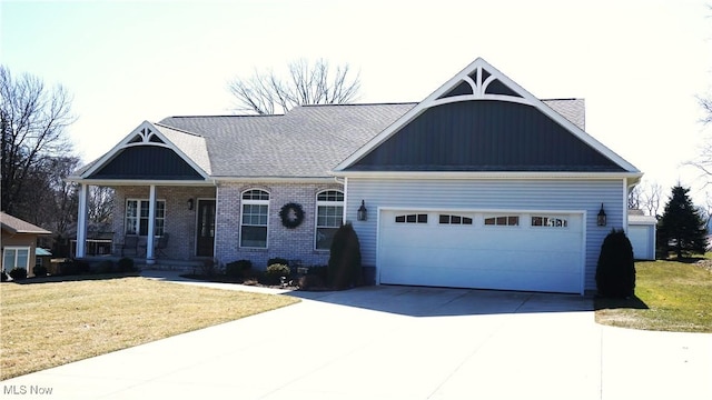 craftsman house with driveway, brick siding, an attached garage, and a front yard