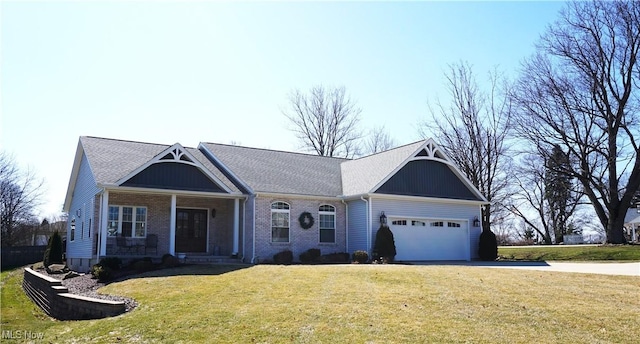 single story home with a front yard, brick siding, a garage, and driveway