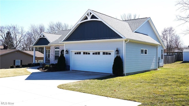 view of front of property with driveway, a shingled roof, a front lawn, a garage, and board and batten siding