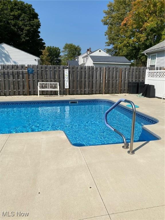 view of swimming pool featuring a patio area, fence, and a fenced in pool