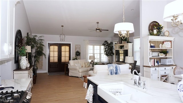 dining room featuring a ceiling fan, light wood-style flooring, and french doors