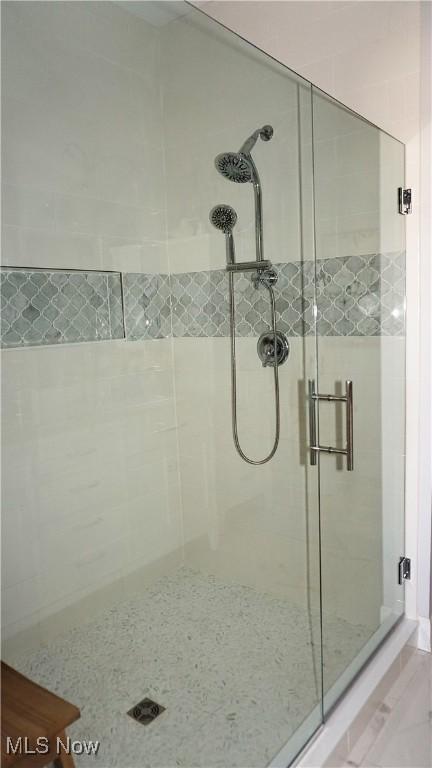 full bath featuring a shower stall