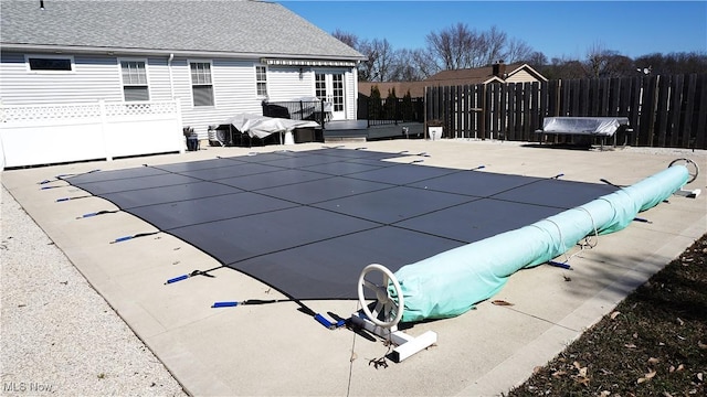 view of swimming pool with a fenced in pool, a deck, and fence