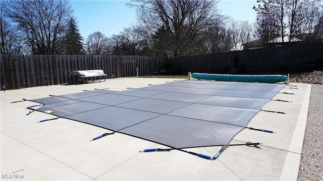 view of pool featuring a fenced in pool, a patio area, and fence