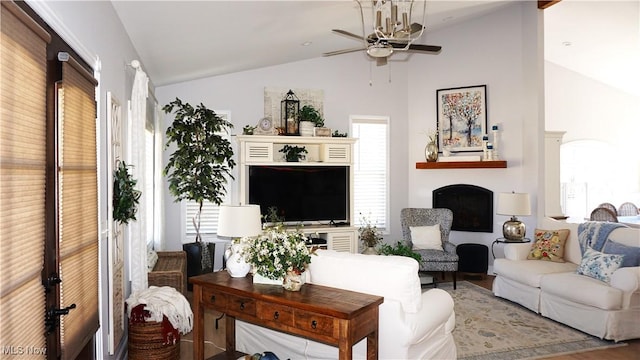 living room featuring a ceiling fan, lofted ceiling, and a fireplace