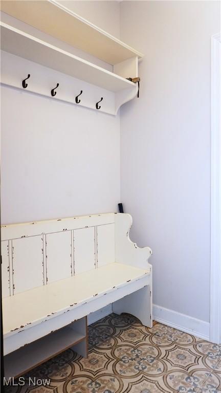 mudroom with light tile patterned flooring and baseboards