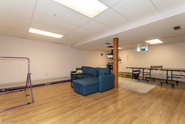 interior space with visible vents, a paneled ceiling, and wood finished floors