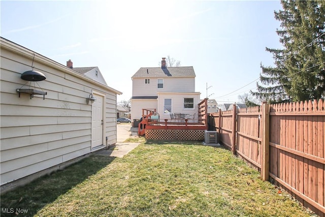 view of yard featuring central air condition unit, a fenced backyard, and a wooden deck