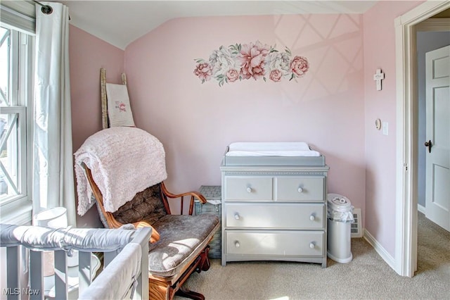 living area with carpet flooring, baseboards, and lofted ceiling