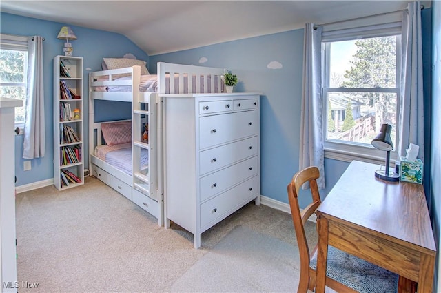 bedroom with baseboards, lofted ceiling, and light colored carpet