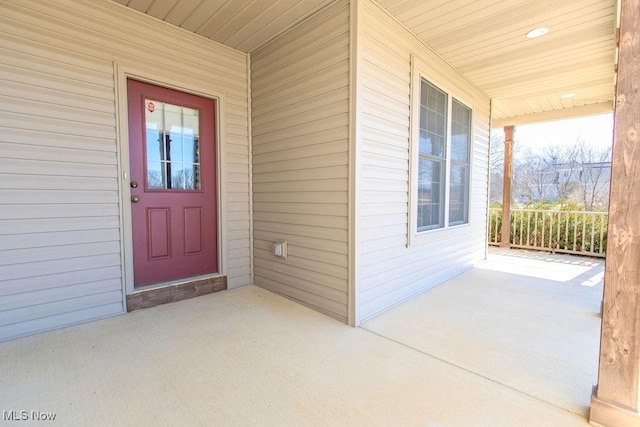 view of exterior entry featuring covered porch