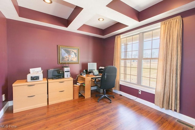 office area with visible vents, baseboards, coffered ceiling, and wood finished floors