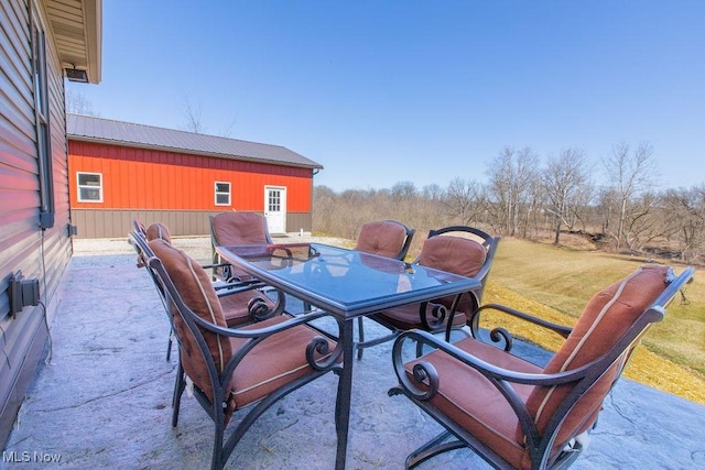 view of patio featuring an outbuilding and outdoor dining space