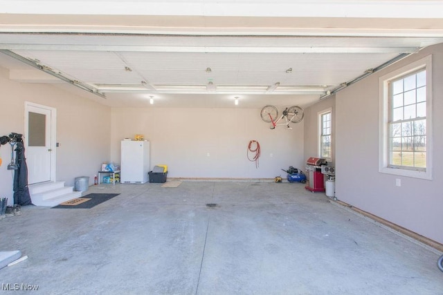 garage with freestanding refrigerator