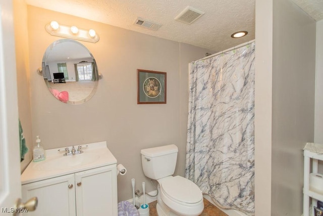 bathroom featuring visible vents, a textured ceiling, and vanity