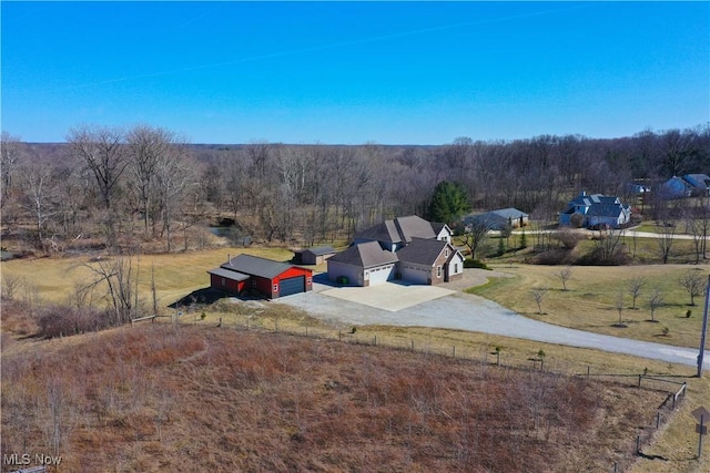 drone / aerial view featuring a forest view