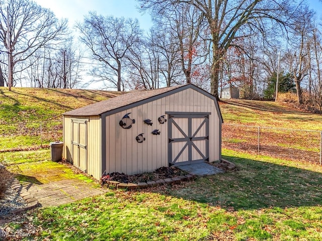 view of shed featuring fence