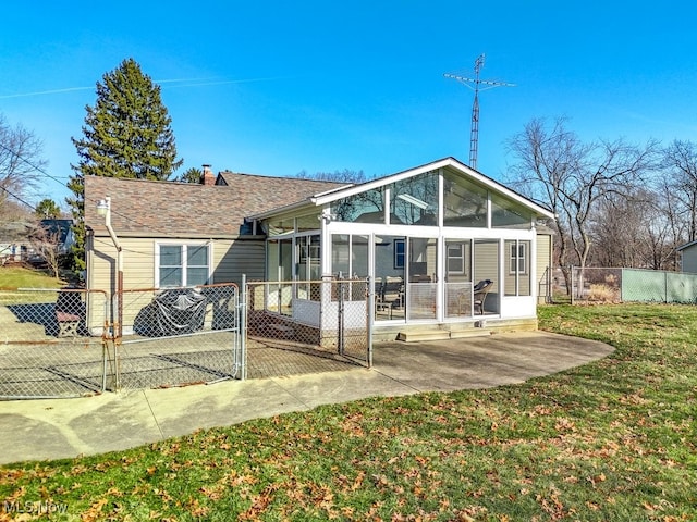 back of property featuring a lawn, a patio, fence, a sunroom, and a chimney