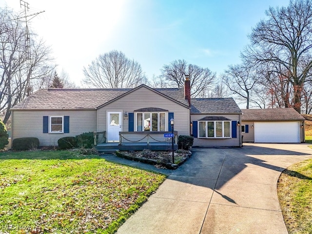 single story home with a detached garage and a front lawn