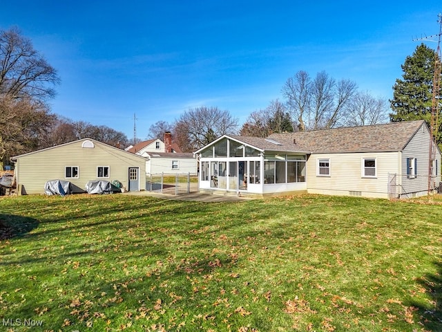 back of house with a patio, a yard, and a sunroom