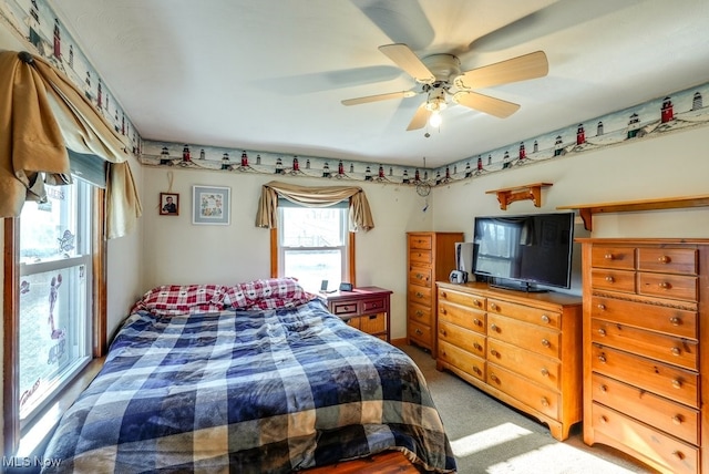 bedroom featuring ceiling fan and light carpet