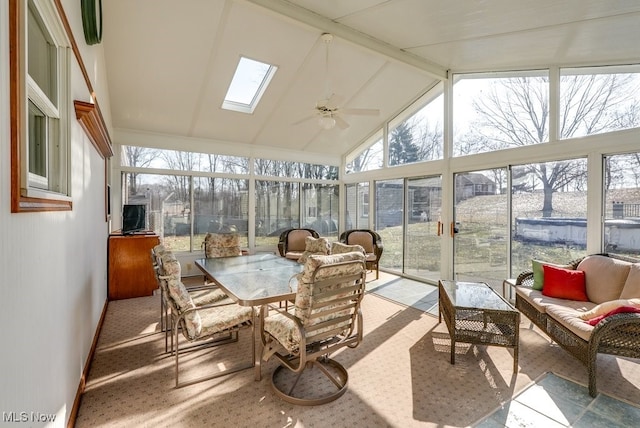 sunroom with vaulted ceiling with skylight and a ceiling fan