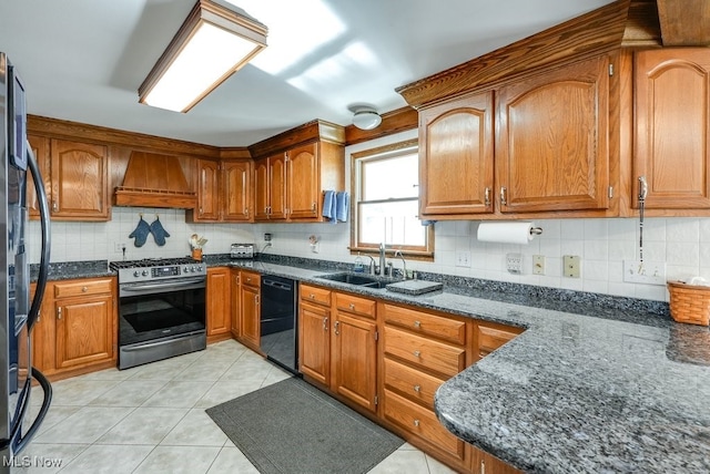 kitchen featuring a sink, brown cabinets, black appliances, and premium range hood