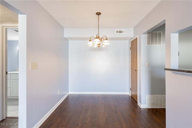 unfurnished dining area with an inviting chandelier, baseboards, and visible vents