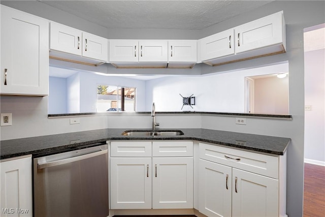 kitchen with dark stone countertops, white cabinetry, a sink, dark wood-type flooring, and dishwasher