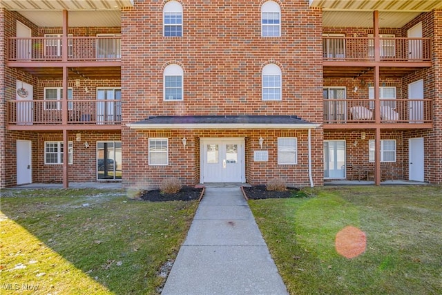 exterior space with a front yard and brick siding