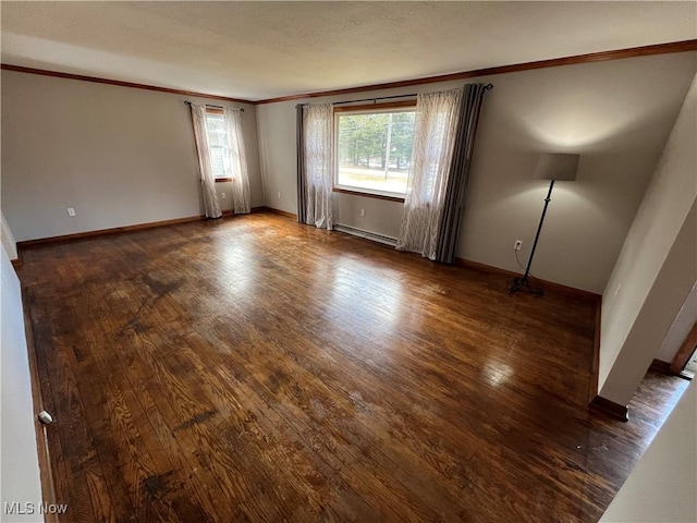 unfurnished room with baseboard heating, ornamental molding, baseboards, and hardwood / wood-style floors