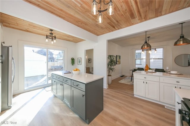 kitchen featuring wooden ceiling, freestanding refrigerator, and a chandelier