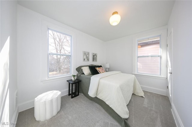 carpeted bedroom featuring baseboards