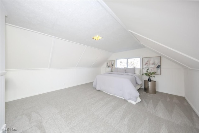 carpeted bedroom with vaulted ceiling