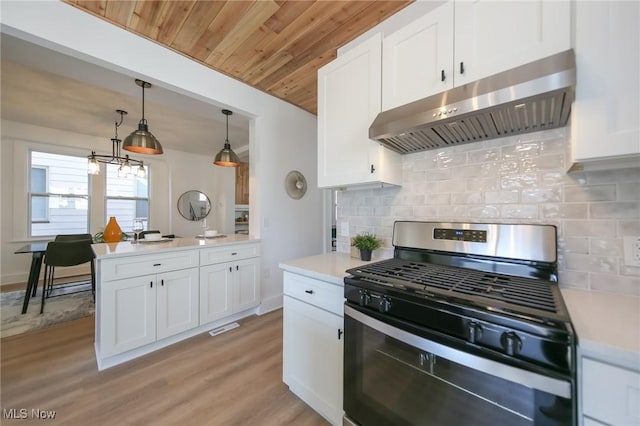 kitchen with stainless steel range with gas stovetop, light countertops, under cabinet range hood, white cabinetry, and light wood-type flooring