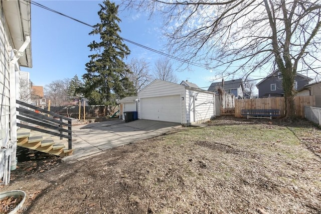 view of yard with an outdoor structure, fence, and a detached garage