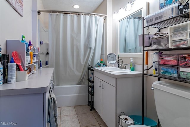 full bathroom featuring tile patterned flooring, toilet, vanity, and shower / bath combo with shower curtain