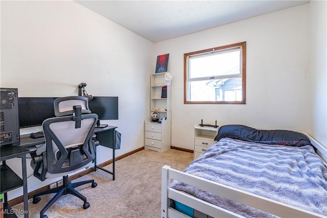 bedroom with baseboards and light carpet