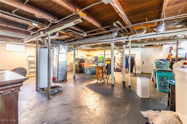 basement featuring heating unit and water heater