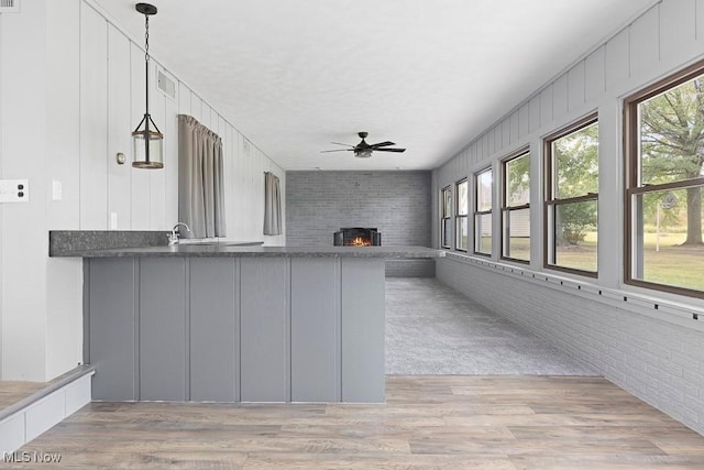 interior space featuring a fireplace and a ceiling fan